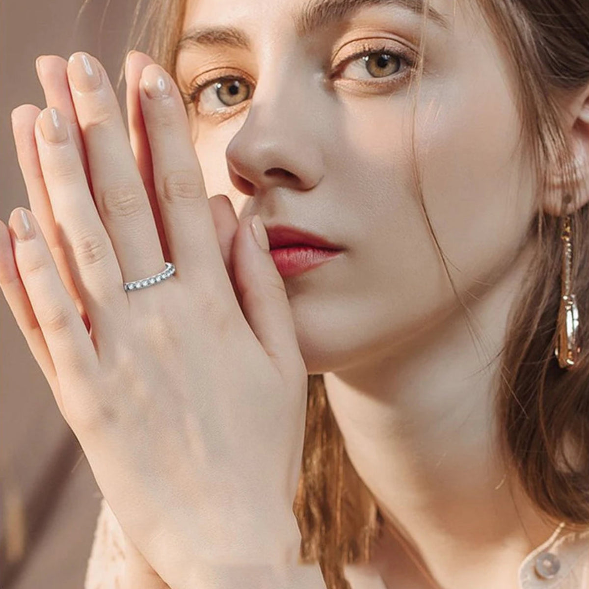 Model wearing moissanite ring on index and ring fingers – minimalist elegance
