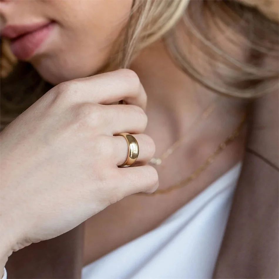 Side view of a lightweight, golden dome-shaped ring.