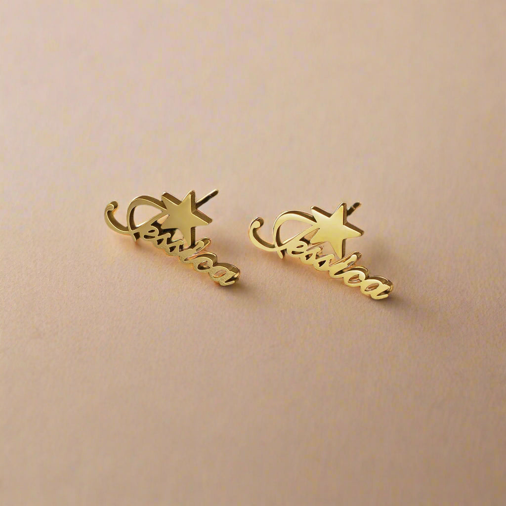 Gold name earrings with star design on black leather.