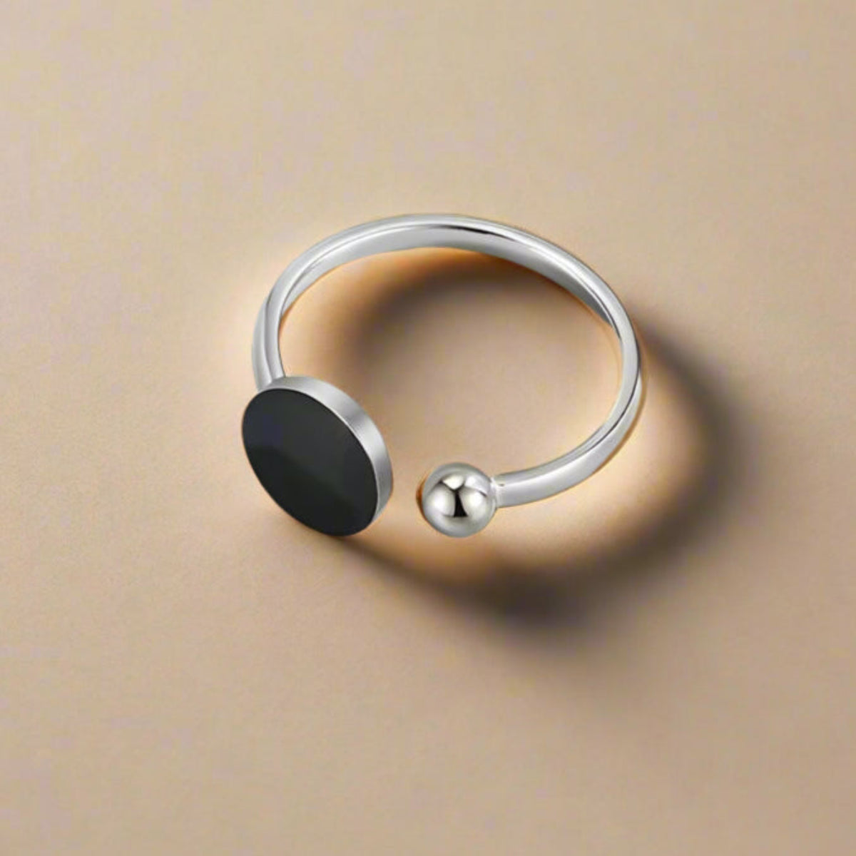 Minimalist ring with bold black resin center – flat lay display