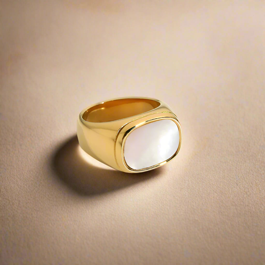 Elegant golden ring with a lustrous pearl accent.