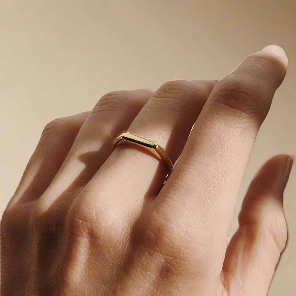 Side view of sleek gold banded ring