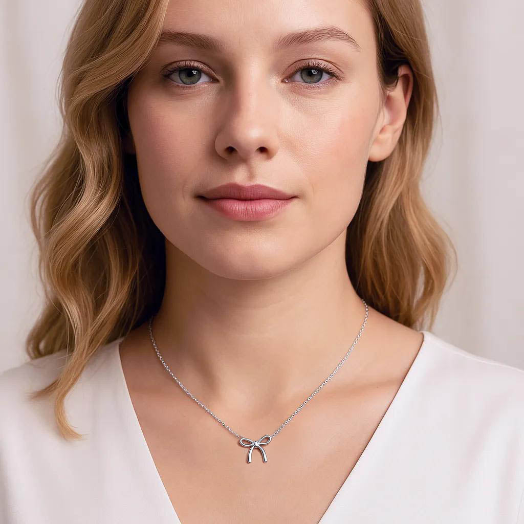 Close-up of elegant bow pendant in silver