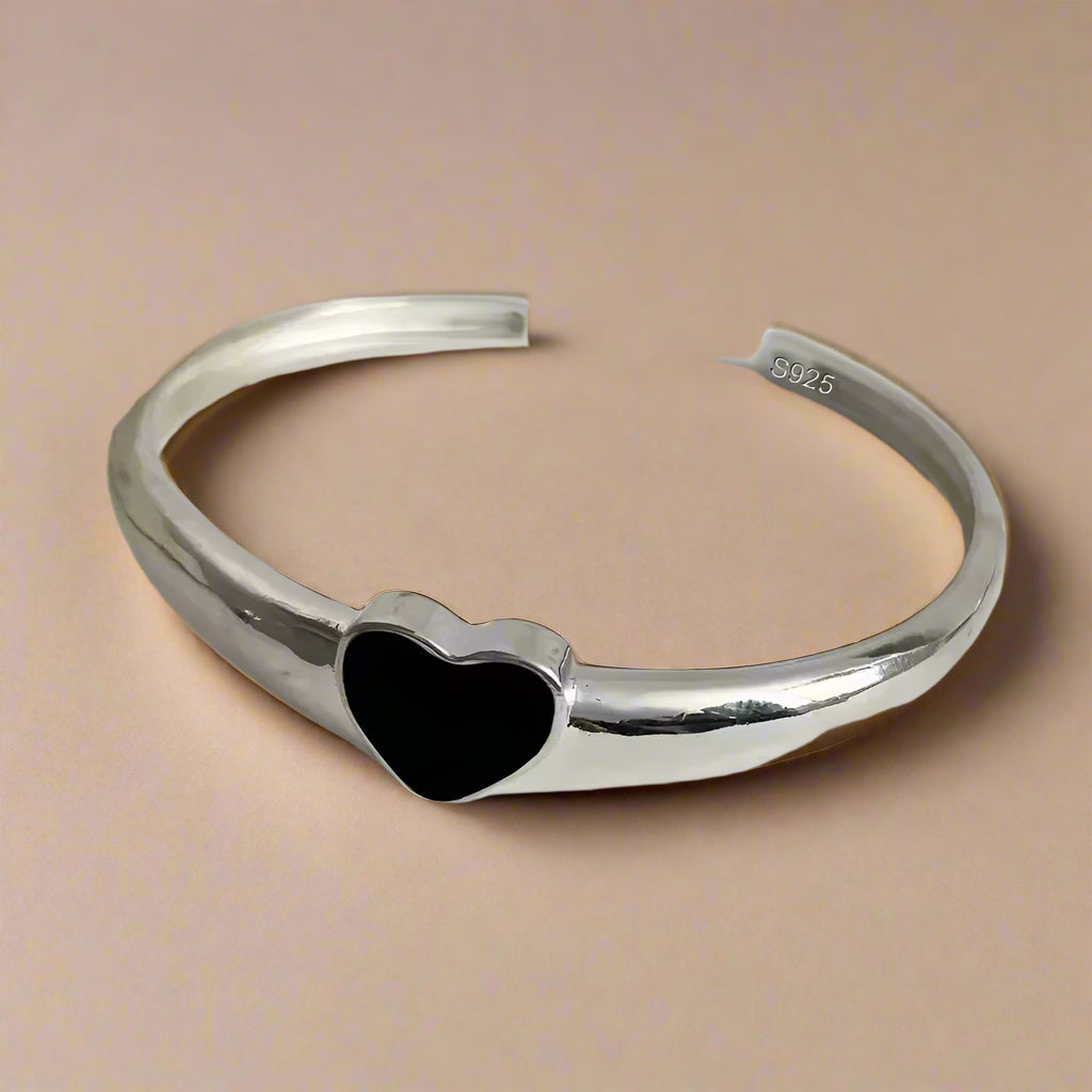 Elegant heart-shaped silver cuff bracelet with glossy finish