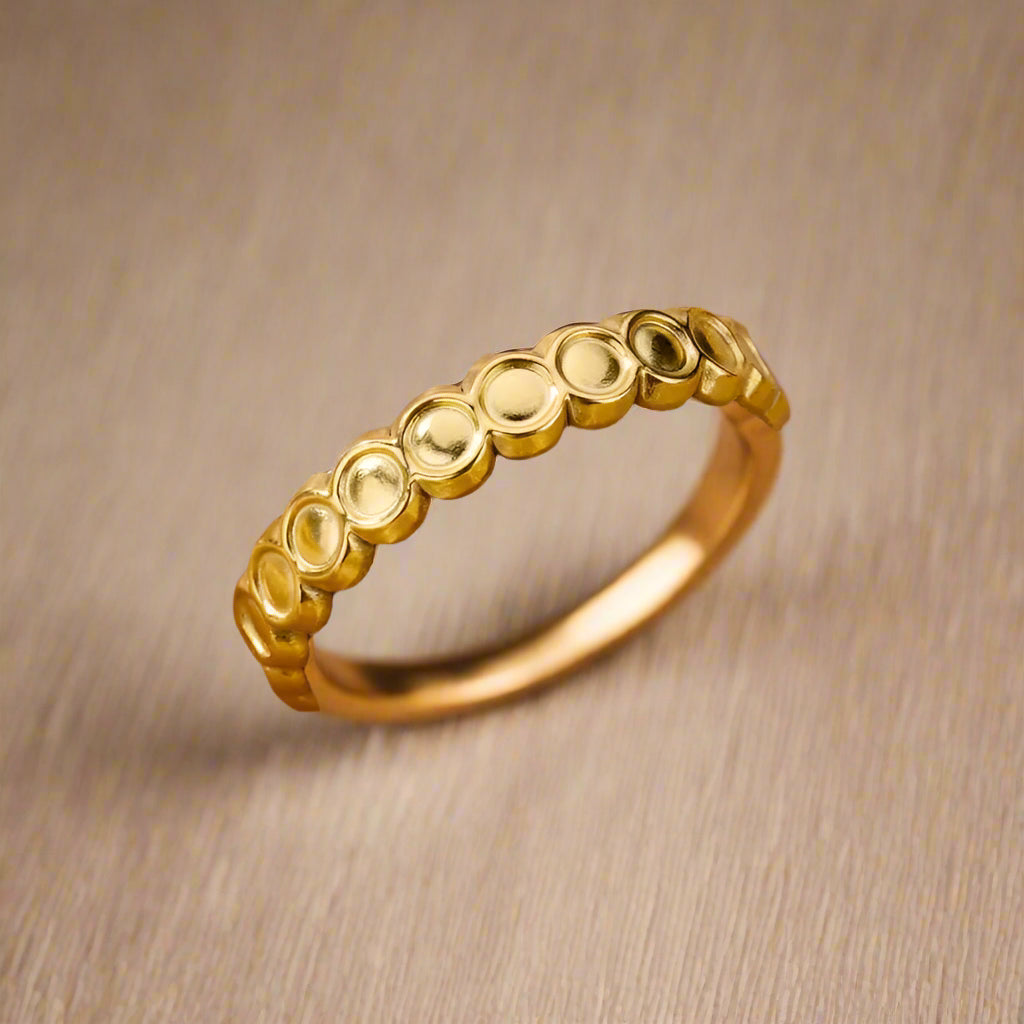 Adjustable gold-plated ring showcasing circle details. 