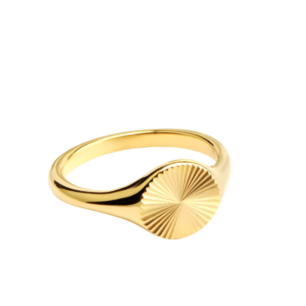  Gold ring with sunburst design on a circular face.