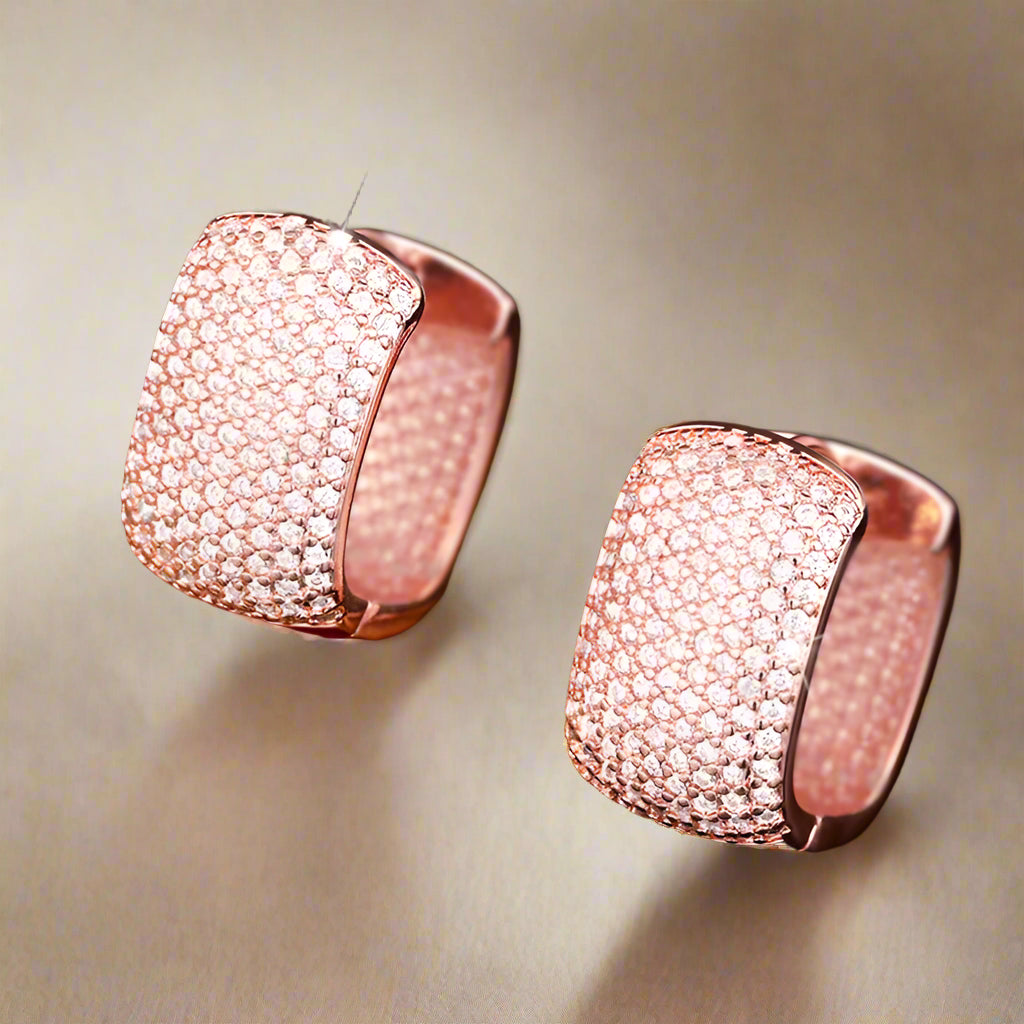 Close-up of silver and gold cubic zirconia earrings