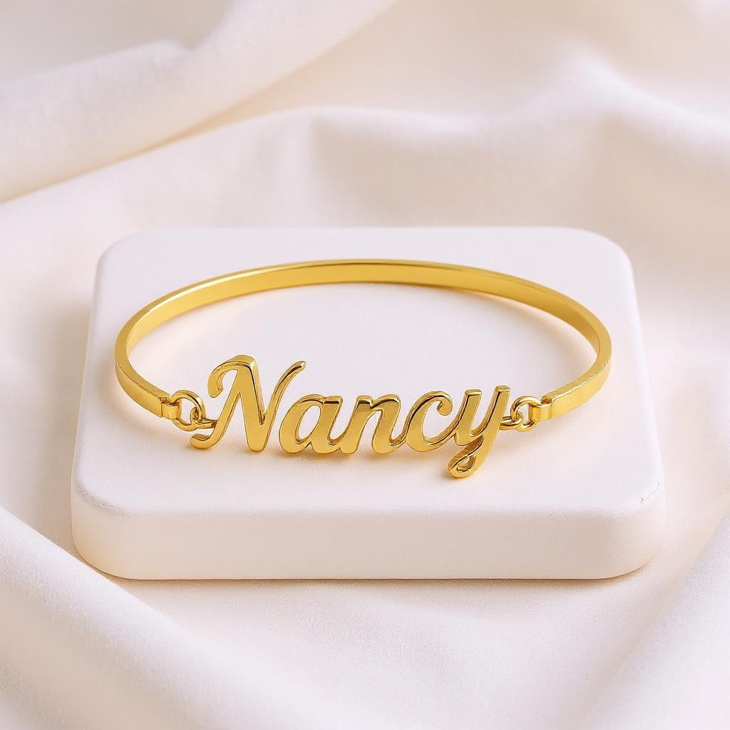 Gold bracelet with 'Nancy' engraving on a white box