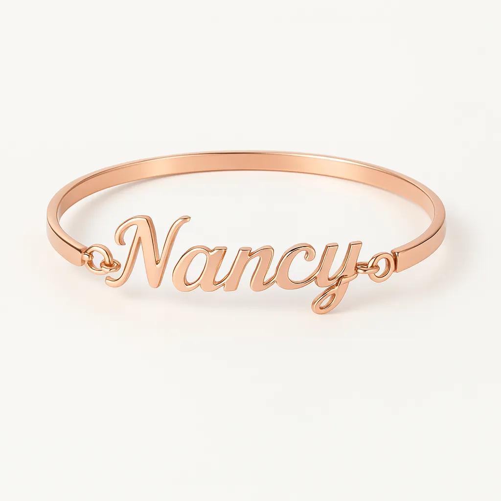 Rose gold bracelet with 'Nancy' engraving on a white background