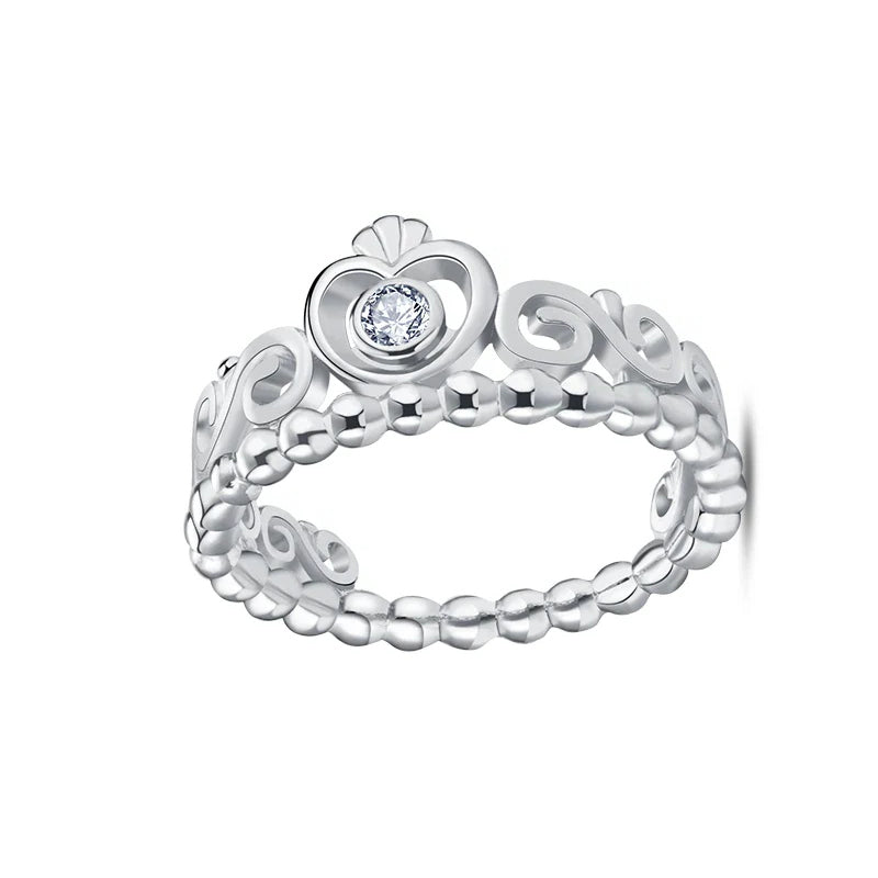 Silver ring with a heart-shaped design and central gemstone on a white background