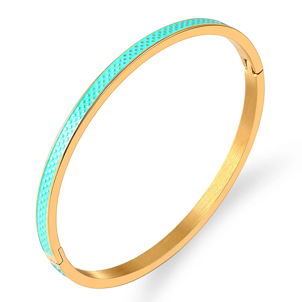 Gold bangle with turquoise interior on a white background