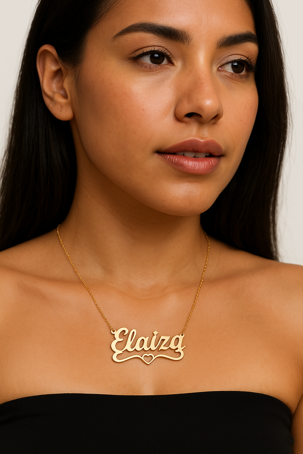 Close-up of personalized gold necklace in elegant script.