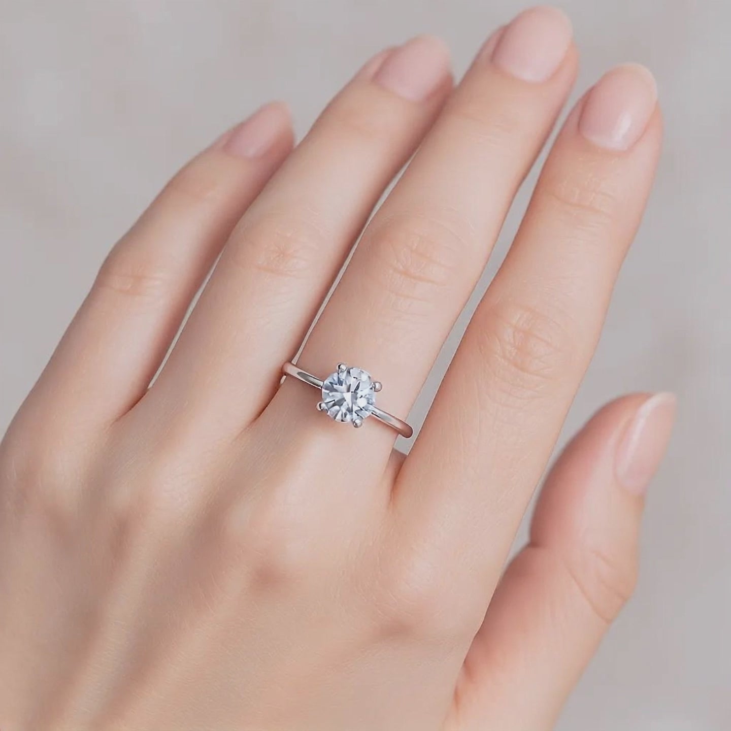 Minimalist moissanite solitaire ring displayed in gift packaging